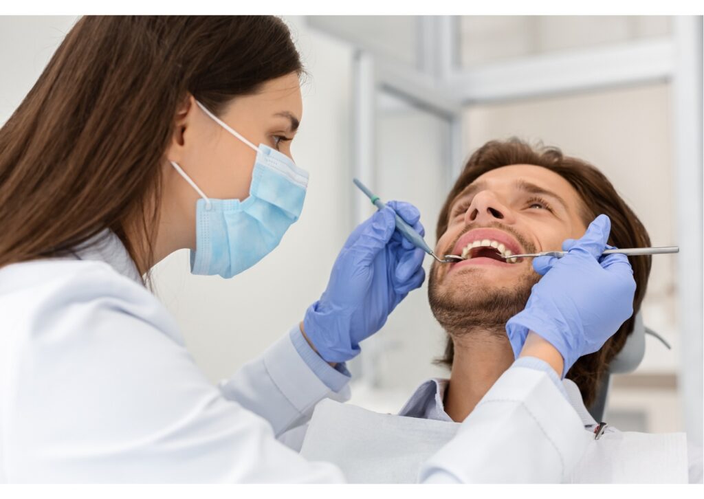 Dentist examining a patient for signs of teeth grinding and recommending a custom nightguard