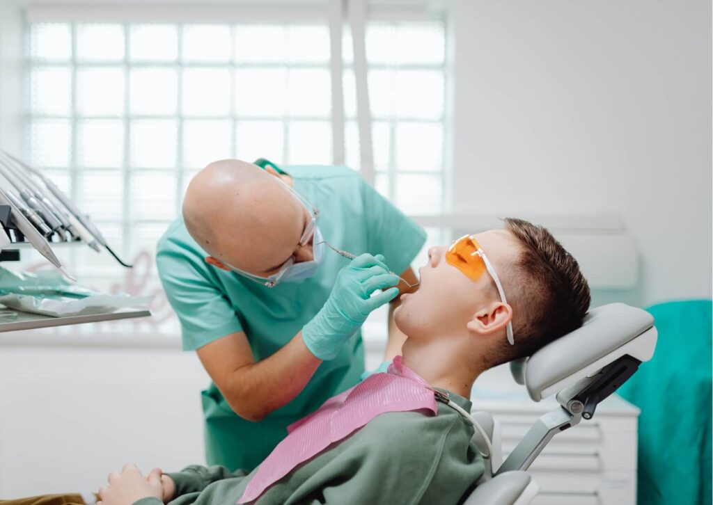 Patient undergoing a dental examination to identify symptoms of a cracked tooth, including pain when biting, chewing, or releasing pressure.