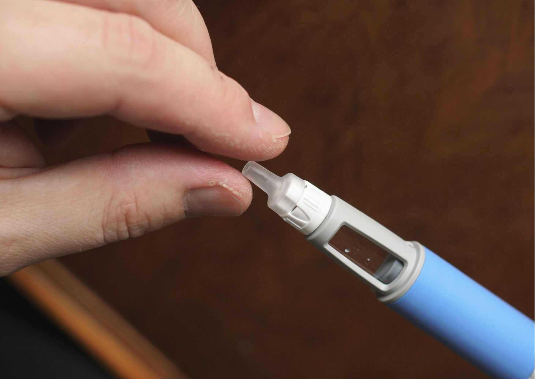 Close-up of a blood glucose testing device, illustrating the connection between diabetes medications like Ozempic and oral health changes that can affect teeth and gums.