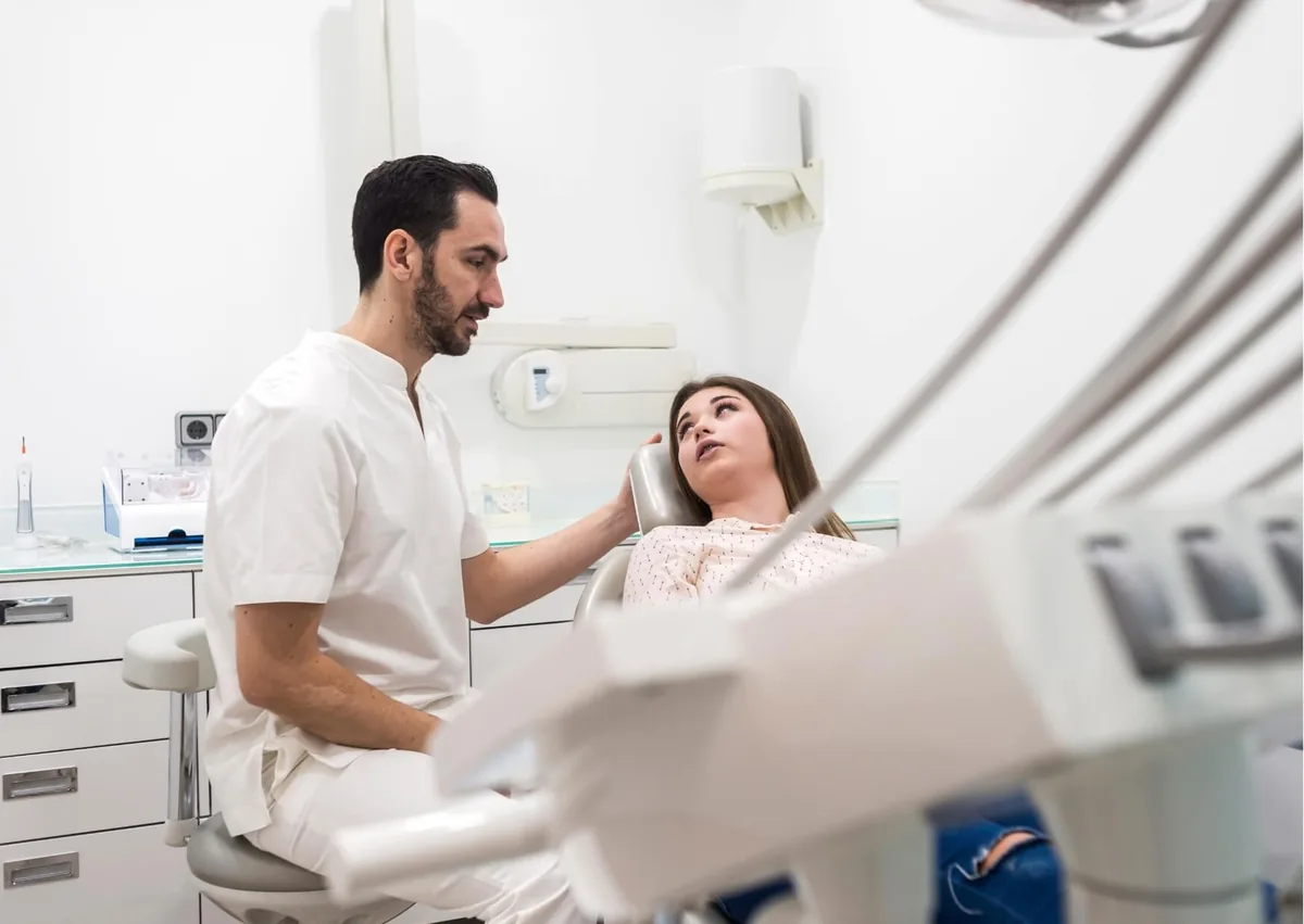 Woman discussing possible sleep apnea symptoms with a dental professional during a consultation.